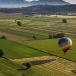 Hot air balloon about to land after flying over a lush landscape of Ampurdà. Learn how to describe the purpose of the image (opens in a new tab). Leave it empty if the image is purely decorative.