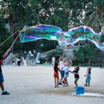 A man who frequents Ciutadella Park creates bubbles through a system of rope, water, and soap for the enjoyment of children. Learn how to describe the purpose of the image (opens in a new tab). Leave it empty if the image is purely decorative.