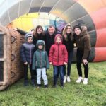 Family poses in front of a hot air balloon after finishing the activity. Learn how to describe the purpose of the image (opens in a new tab). Leave it empty if the image is purely decorative.