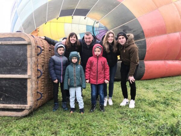 Family poses in front of a hot air balloon after finishing the activity. Learn how to describe the purpose of the image (opens in a new tab). Leave it empty if the image is purely decorative.