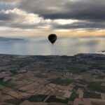 Hot air balloon flying over the Catalan landscape of Empordà. Learn how to describe the purpose of the image (opens in a new tab). Leave it empty if the image is purely decorative.