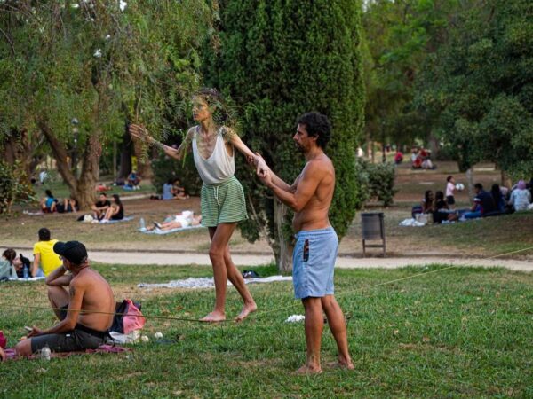Two people are in one of the green spaces of Ciutadella Park, engaging in some form of scenic or spiritual exercise. Learn how to describe the purpose of the image (opens in a new tab). Leave it empty if the image is purely decorative.