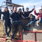 A family poses on a truck heading to the flatland where hot air balloons rise for a family evening in the air. Learn how to describe the purpose of the image (opens in a new tab). Leave it empty if the image is purely decorative.