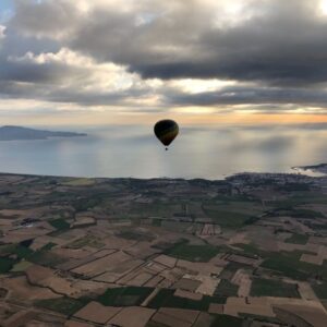 Hot air balloon flying over the landscapes of Empordà.