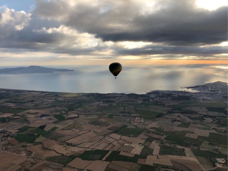 Hot air balloon flying over the landscapes of Empordà.