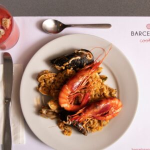 Steaming paella dish served with a colorful array of seafood and aromatic rice.