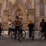 Group with bikes receiving explanations at Barcelona Cathedral.