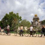 Group posing at the fountain with bikes in Parc de la Ciutadella, Barcelona.