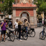 Group of people with bikes looking at the camera in Gràcia, Barcelona.