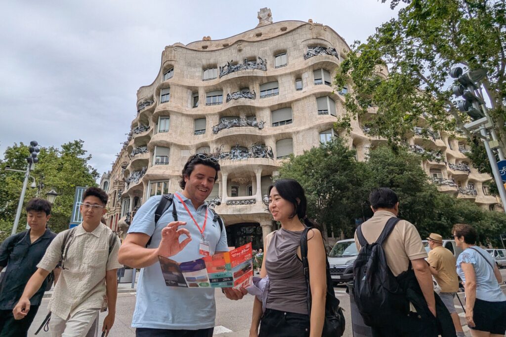Tourists with a map in front of Casa Milà (La Pedrera).