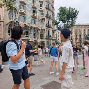 Tour guide pointing at architectural details of Casa Batlló.