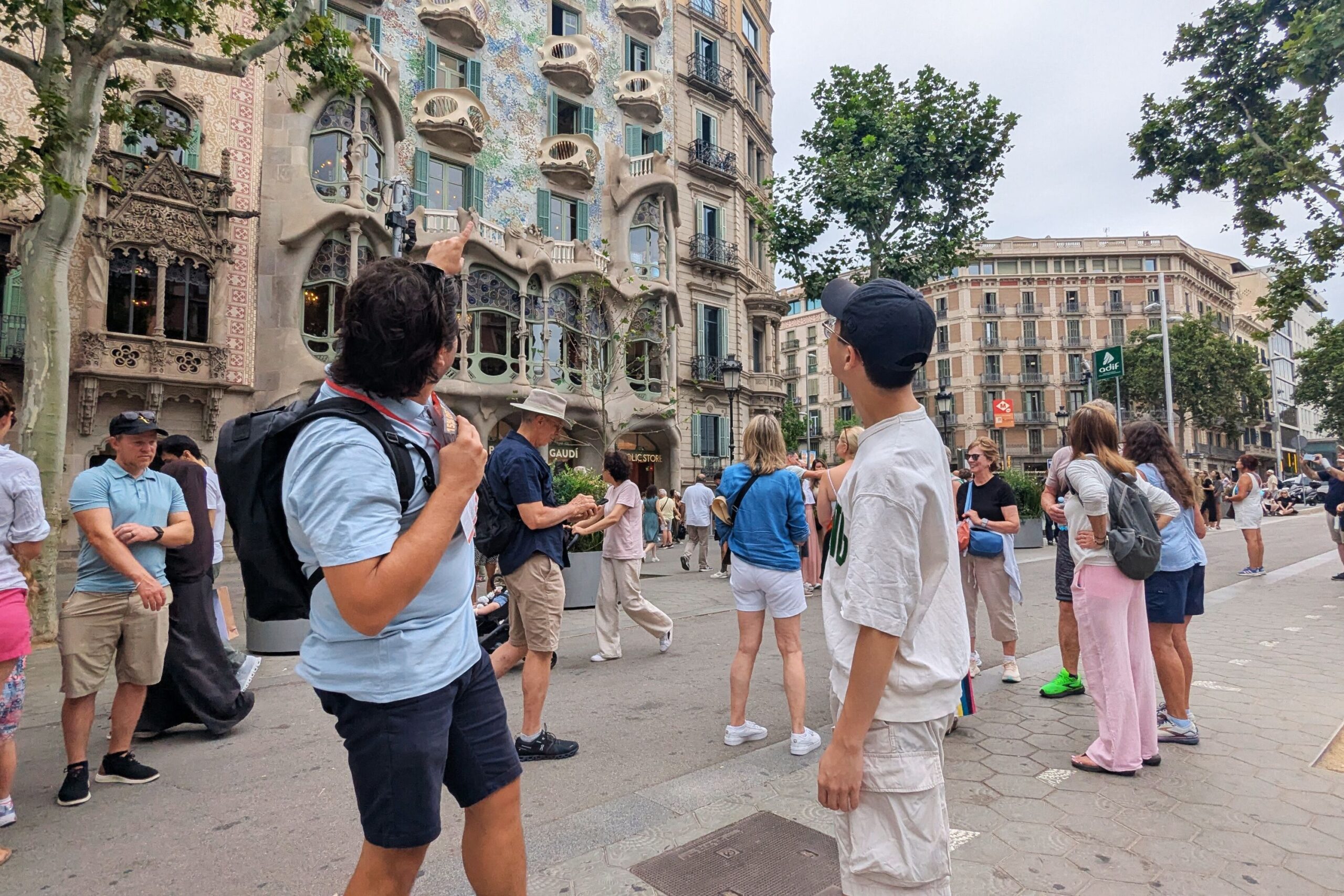 Tour guide pointing at architectural details of Casa Batlló.
