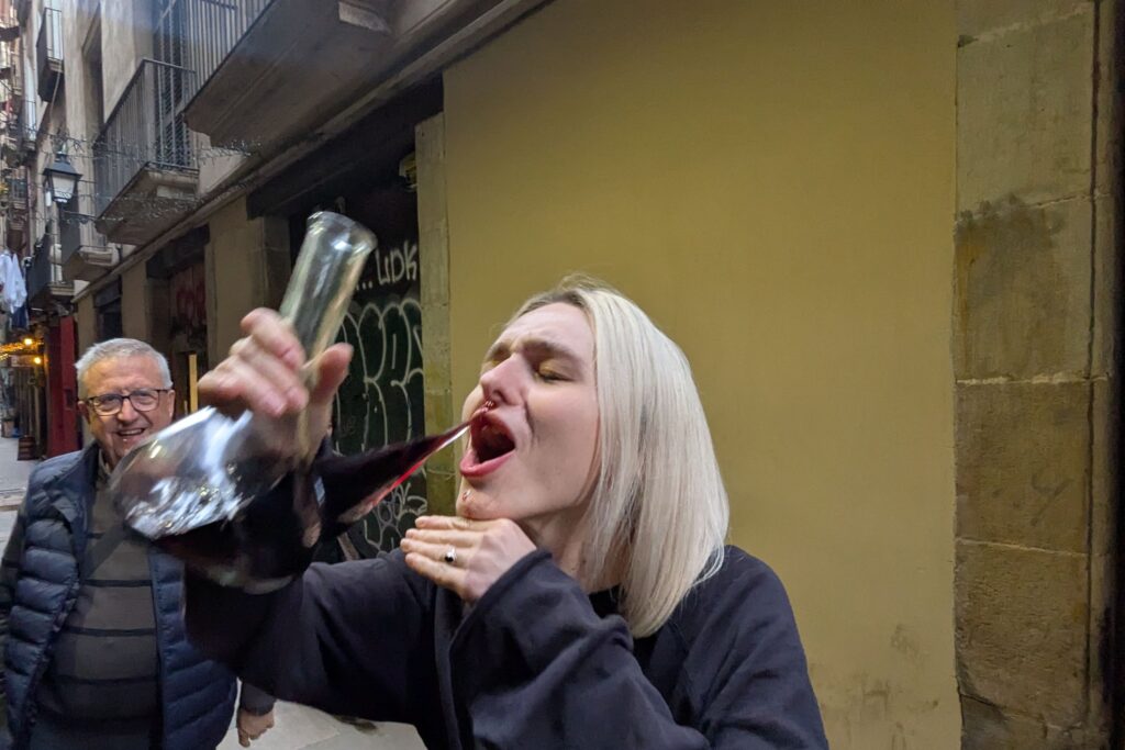 Guest drinking wine during a Barcelona tapas tour